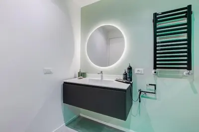 a bathroom with a sink and a mirror at The Heart of Rome Luxury House in Rome