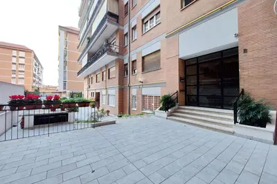 an empty courtyard of a building with flowers on it at Lovely apartment with terrace near the Vatican in Rome