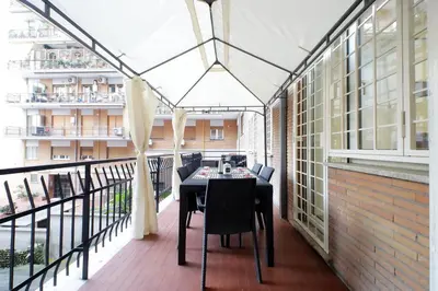 a balcony with a table and chairs on it at Lovely apartment with terrace near the Vatican in Rome
