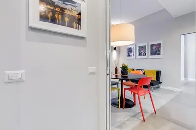 a dining room with a table and a red chair at CasaDoria51 in Rome