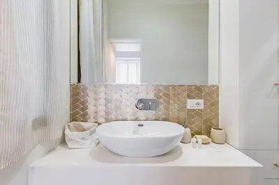 a bathroom with a white sink and a mirror at CasaDoria51 in Rome