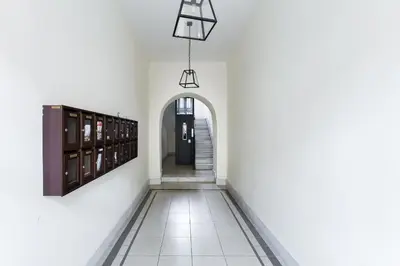 a hallway with white walls and a black door at CasaDoria51 in Rome