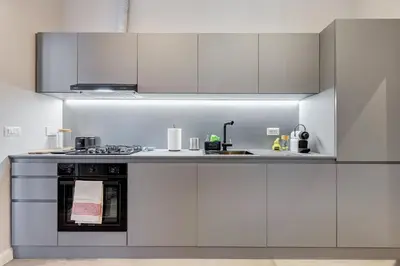 a kitchen with white cabinets and a stove at CasaDoria51 in Rome