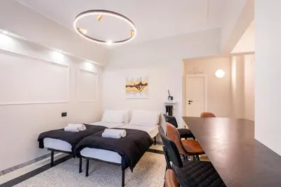 a bedroom with a bed and a table and chairs at LUCIANO LUXURY APARTMENT in Rome