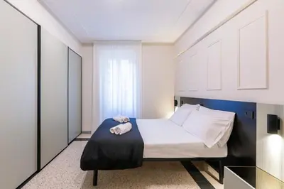 a bedroom with a bed with towels on it at LUCIANO LUXURY APARTMENT in Rome