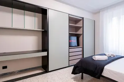 a bedroom with a bed and a tv at LUCIANO LUXURY APARTMENT in Rome