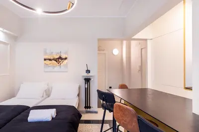a room with a bed and a table with chairs at LUCIANO LUXURY APARTMENT in Rome