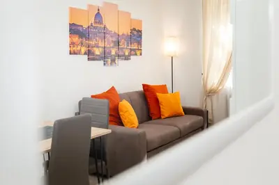 a living room with a couch and a table at Domus Opimiani in Rome