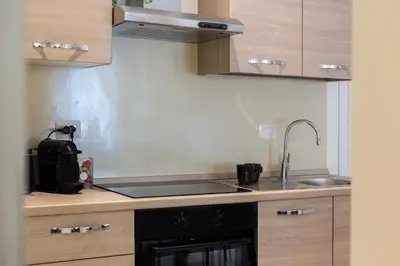 a kitchen with a sink and a stove at Domus Opimiani in Rome