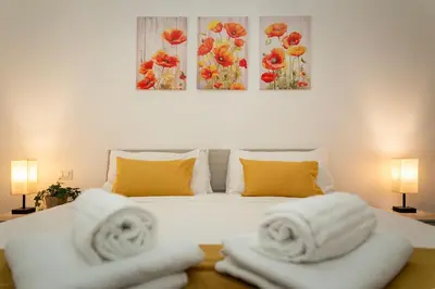 a white bed with two towels on top of it at Domus Opimiani in Rome