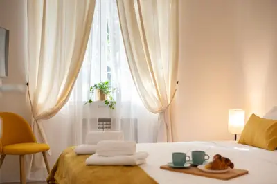 a bedroom with a bed with two plates of food on it at Domus Opimiani in Rome