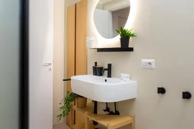 a bathroom with a white sink and a mirror at Domus Opimiani in Rome