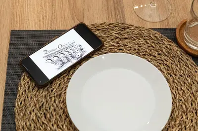 a cell phone sitting on a table next to a plate at Domus Opimiani in Rome