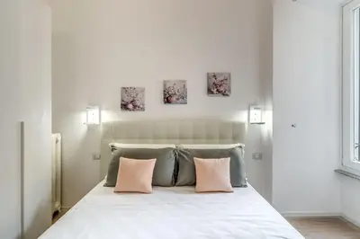 a bedroom with a bed with two pillows at Vatican Portrait Suites in Rome
