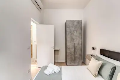 a living room with a couch and a sliding door at Vatican Portrait Suites in Rome