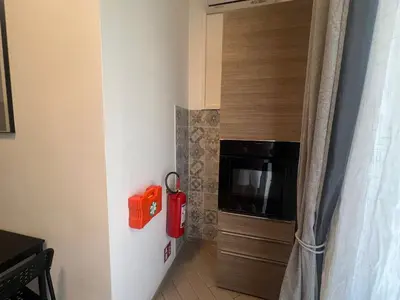a kitchen with a fire hydrant next to a wall at Casa Gemelli in Rome