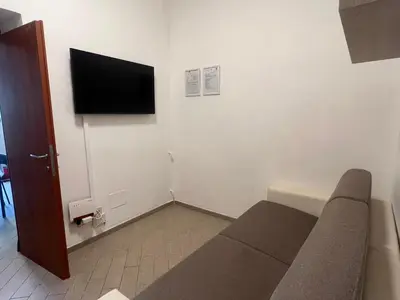 a living room with a couch and a flat screen tv at Casa Gemelli in Rome