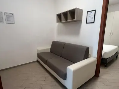 a hospital room with a couch and a bed at Casa Gemelli in Rome