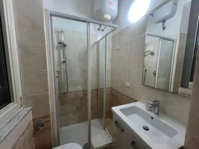 a bathroom with a shower and a toilet and a sink at Casa Gemelli in Rome