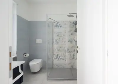 a bathroom with a glass shower with a toilet at @uRhOME - Luxury Accommodation in Rome