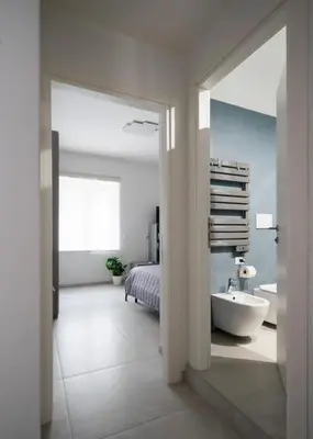 a bedroom with a bed and a bathroom with a tub at @uRhOME - Luxury Accommodation in Rome