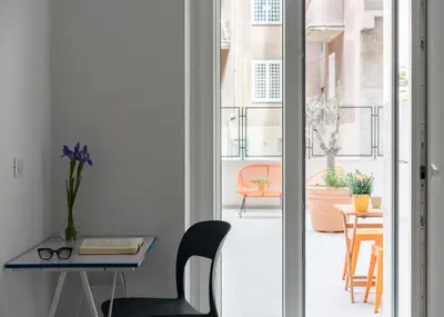 a room with a desk and a table with a chair at @uRhOME - Luxury Accommodation in Rome