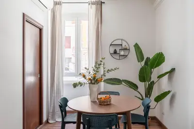 a dining room with a table and a potted plant at iFlat Colosseum Charming Flat in Rome