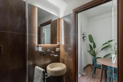 a bathroom with a toilet and a table at iFlat Colosseum Charming Flat in Rome