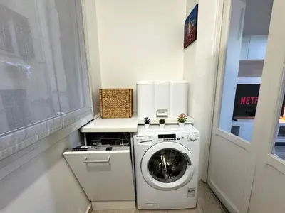 a white washer and dryer in a room with a window at AmoR San Lorenzo in Rome