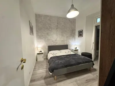 a bedroom with a bed and two night stands at AmoR San Lorenzo in Rome