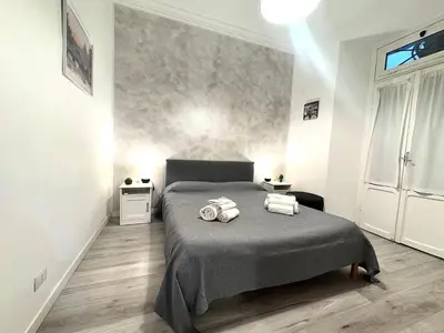 a bedroom with a bed with two towels on it at AmoR San Lorenzo in Rome