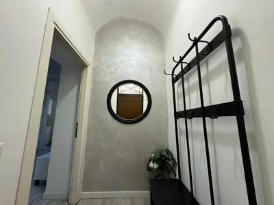a hallway with a round mirror on a wall at AmoR San Lorenzo in Rome