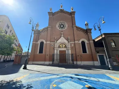 a church with a large brick building with a door at AmoR San Lorenzo in Rome