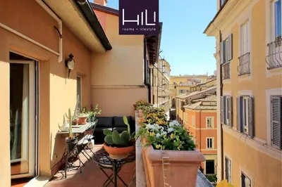 a balcony with potted plants on the side of a building at 3V Luxury Apartment by Hili in Rome