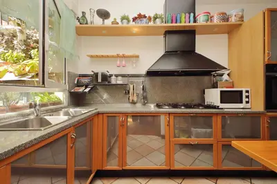 a kitchen with a stove and a microwave at 3V Luxury Apartment by Hili in Rome