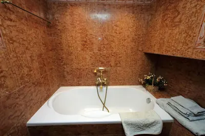 a bathroom with a bath tub with a sink at 3V Luxury Apartment by Hili in Rome