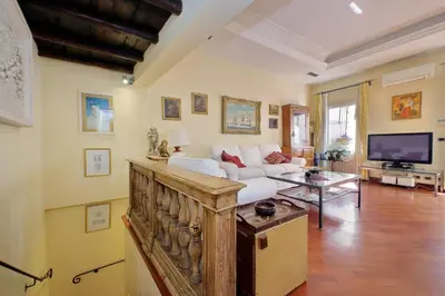 a living room with a white couch and a tv at 3V Luxury Apartment by Hili in Rome