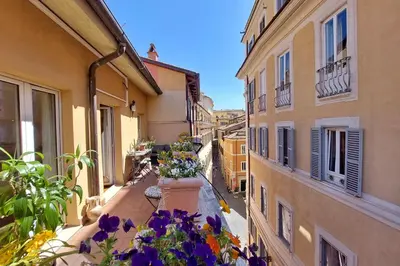 an apartment balcony with flowers on the side of a building at 3V Luxury Apartment by Hili in Rome