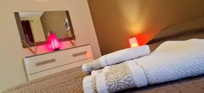 a bedroom with a bed with a dresser and a mirror at Holiday home Telese Roma in Rome