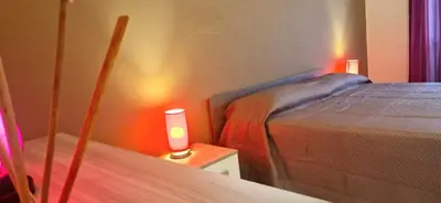 a bedroom with a bed and a candle on a table at Holiday home Telese Roma in Rome