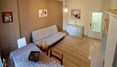 a living room with a couch and a table at Holiday home Telese Roma in Rome