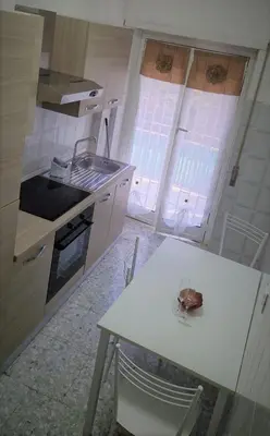 a kitchen with a table and a sink and some windows at Holiday home Telese Roma in Rome