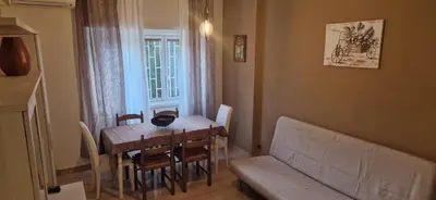 a living room with a table and a couch at Holiday home Telese Roma in Rome
