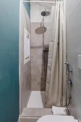 a bathroom with a shower with a shower curtain at La Casetta a Monti in Rome