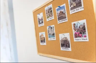 a cork bulletin board with pictures on it at Large Garden in Rome