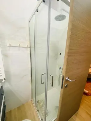 a shower with a glass door in a bathroom at Large Garden in Rome