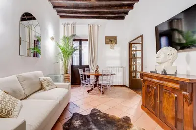 a living room with a couch and a table at GIULIO CESARE DELUXE - Spanish Step RomeDreamHome in Rome