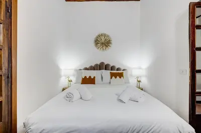 a white bedroom with a large white bed at GIULIO CESARE DELUXE - Spanish Step RomeDreamHome in Rome