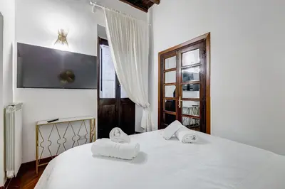 a bedroom with a white bed with towels on it at GIULIO CESARE DELUXE - Spanish Step RomeDreamHome in Rome