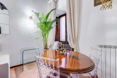 a dining room with a wooden table and chairs at GIULIO CESARE DELUXE - Spanish Step RomeDreamHome in Rome